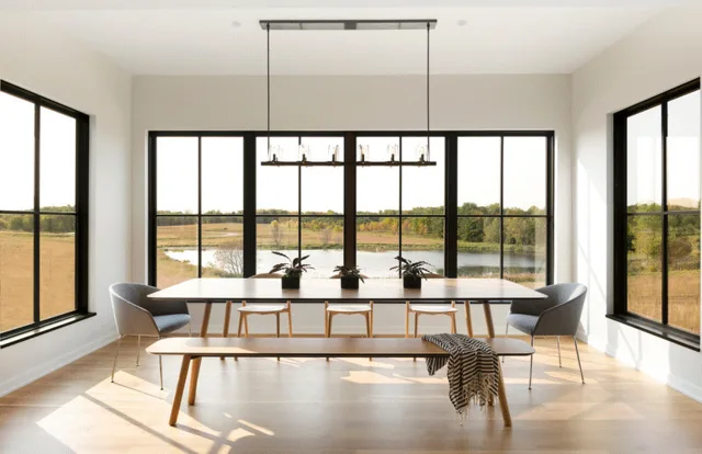 Black-framed replacement windows opening to a bright interior view in Georgetown, Texas