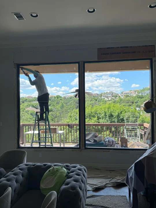 JP Exteriors installer preparing a replacement window in a Georgetown, Texas home